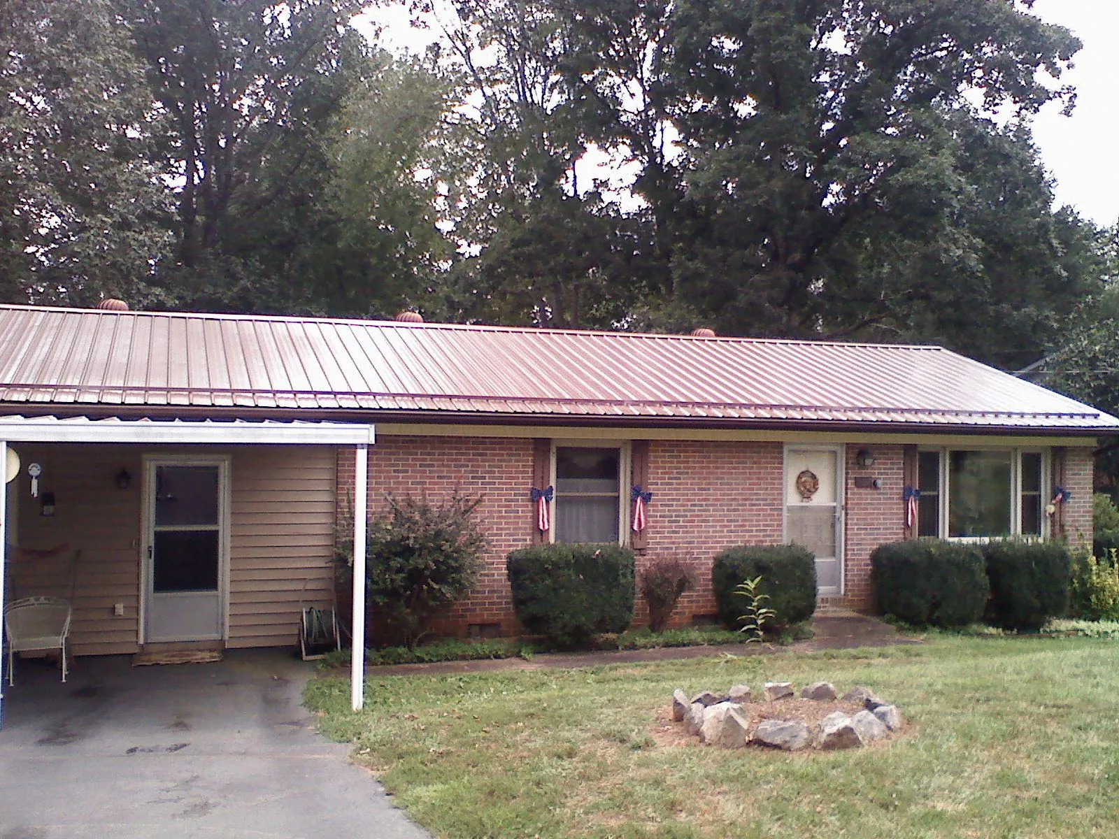 Bronze metal roof and carport on a brick ranch home — Roof Repair work by our crew in Elsinore