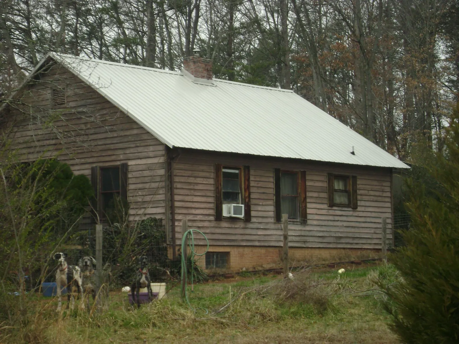 White metal roof on an old wood sided farmhouse, from a Metal Roof Installation job in Elsinore